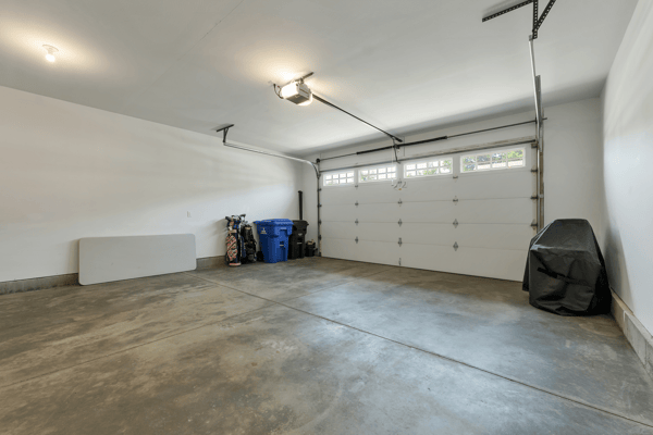 Spacious garage with ample room for storage and parking, featuring a modern overhead door.