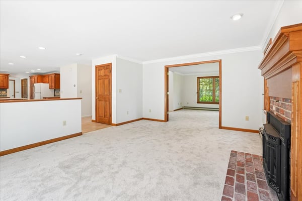 Spacious living area features cozy fireplace and connects seamlessly to the kitchen for easy entertaining.