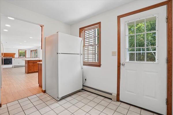 Bright kitchen area featuring convenient access to outdoor space and spacious layout, perfect for entertaining.