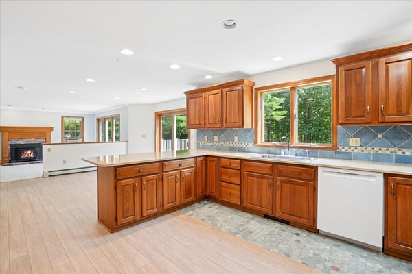 Spacious kitchen featuring warm wood cabinetry, ample natural light, and modern appliances, perfect for family gatherings.