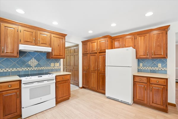 Discover a bright kitchen featuring ample cabinetry, modern appliances, and a functional layout perfect for cooking.