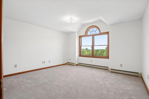Spacious room featuring large window with scenic views, perfect for customization to your taste.