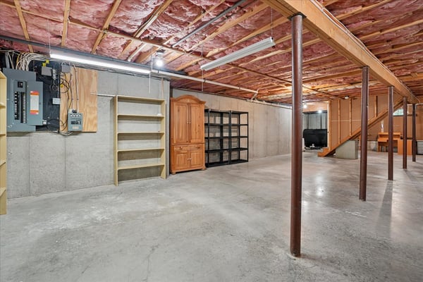 Spacious unfinished basement featuring ample storage options and potential for customization to suit your needs.