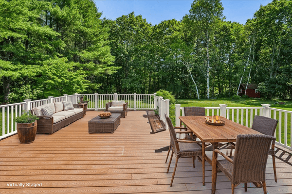 Spacious outdoor deck perfect for entertaining, surrounded by lush greenery and a tranquil atmosphere.