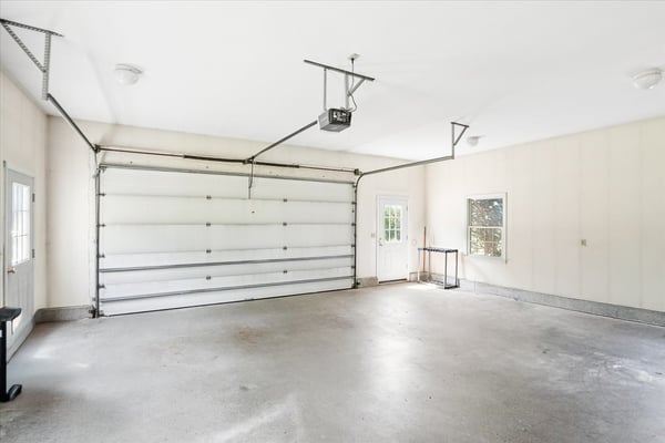 Spacious garage with ample storage and natural light, perfect for parking or a workshop area.