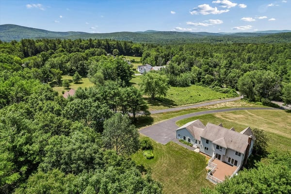 Spacious home nestled in lush greenery, offering panoramic views and ample outdoor space for relaxation.