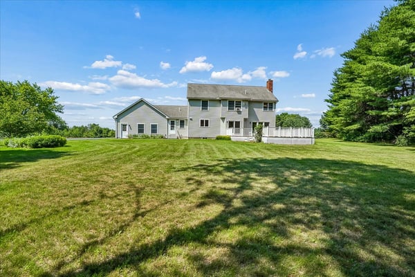 Spacious home on a generous lot, surrounded by greenery and featuring ample outdoor living space.