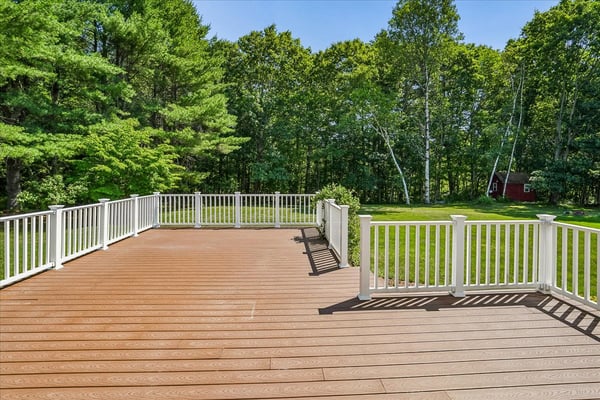 Spacious deck overlooking a large, private yard, perfect for outdoor gatherings and relaxation.