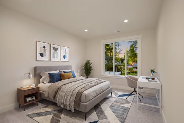 One of three upper-level en-suite bedrooms, this light-filled retreat offers comfort, privacy, and flexibility for guests, loved ones, or evolving household needs. Virtually staged.