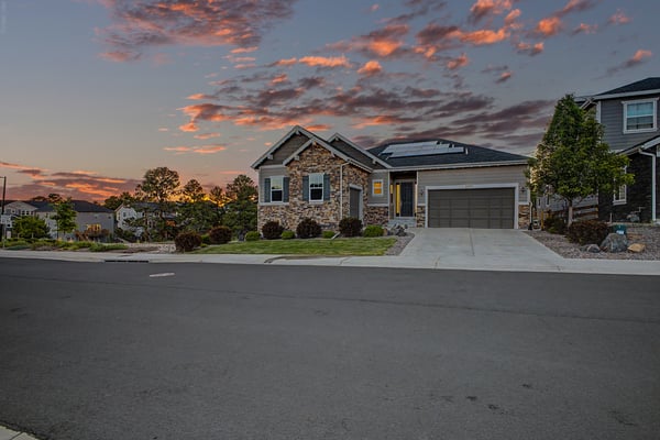 Beautifully designed home featuring modern architecture, landscaped yard, and stunning sunset views in a desirable neighborhood.
