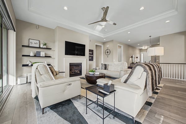 Spacious living area with modern furnishings, gas fireplace, and seamless indoor-outdoor flow for relaxation and entertaining.