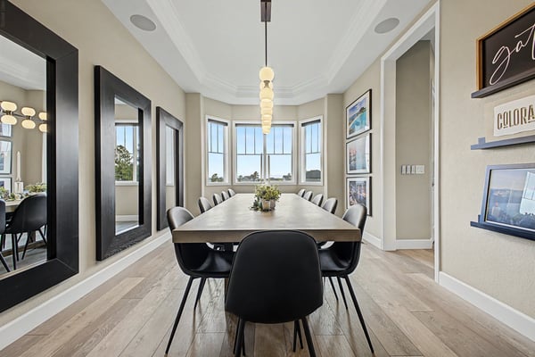 Discover a spacious dining area featuring large windows, modern decor, and ample natural light for gatherings.