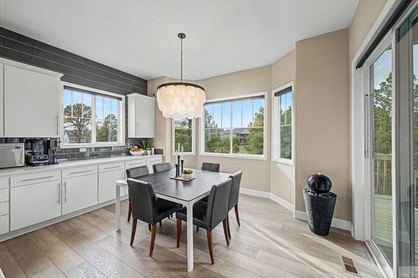 Bright and airy kitchen with large windows, modern fixtures, and a spacious dining area for gatherings.
