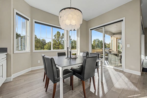 Bright dining area with large windows, offering scenic views and seamless access to outdoor living space.
