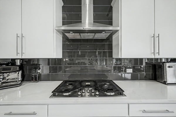 Modern kitchen featuring sleek cabinetry, stainless steel appliances, and a contemporary backsplash for a sophisticated cooking experience.