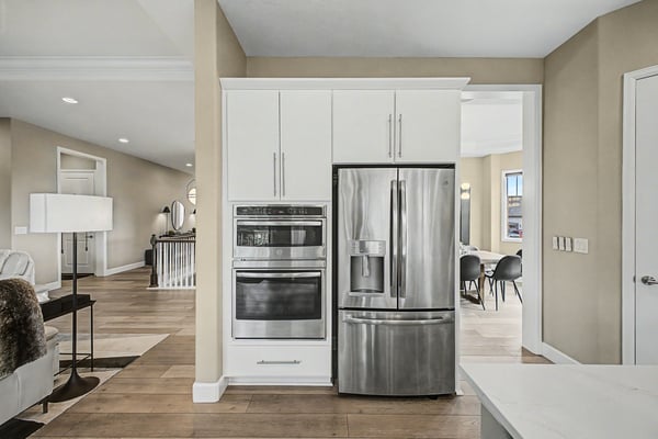 Modern kitchen with stainless steel appliances, open layout, and seamless flow into adjacent living areas.
