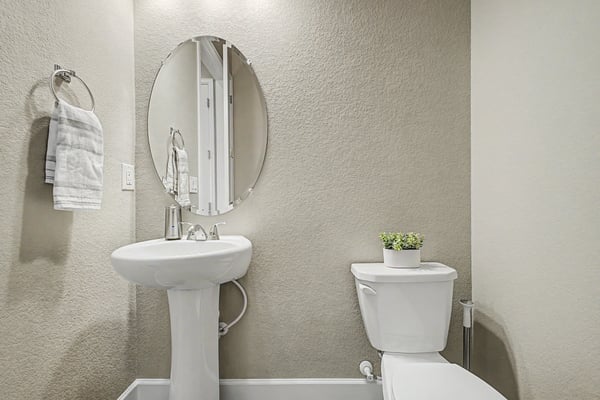 Bright and functional bathroom featuring modern fixtures and a minimalistic design for optimal space utilization.