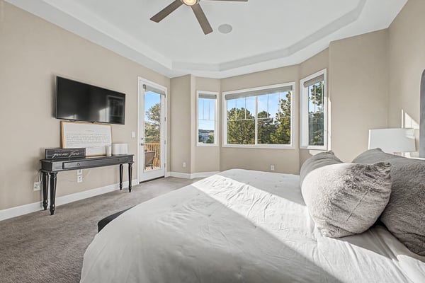 Bright and airy bedroom with expansive windows and modern amenities, perfect for relaxation and comfort.