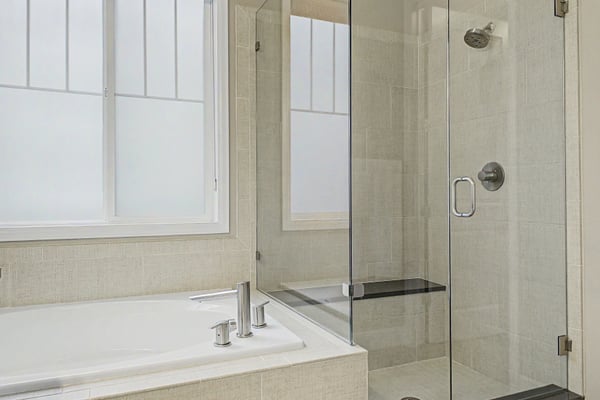 Bright and modern bathroom featuring a spacious walk-in shower and a luxurious soaking tub.