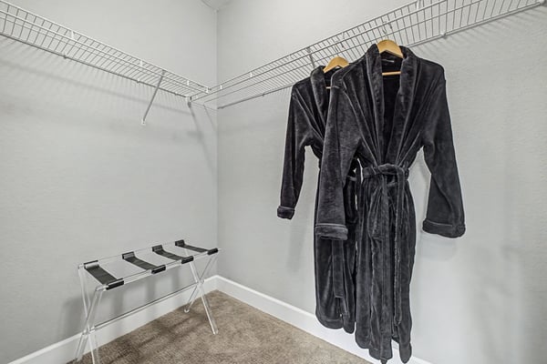 Spacious walk-in closet featuring ample storage, perfect for organizing your wardrobe and accessories.