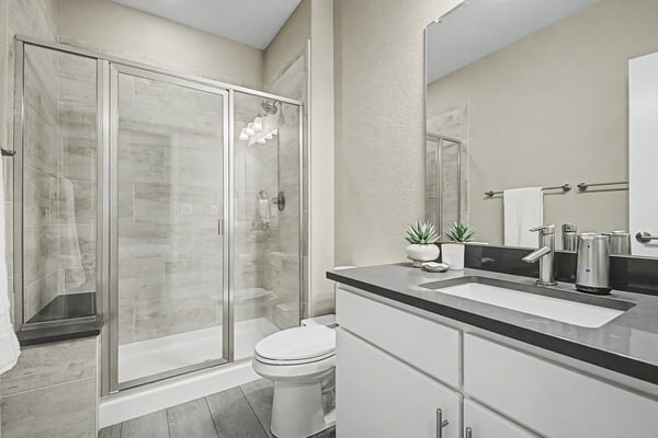 Modern bathroom featuring a sleek design with glass shower enclosure and contemporary fixtures.