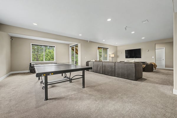 Spacious and versatile living area perfect for recreation and relaxation, featuring ample natural light and modern amenities.