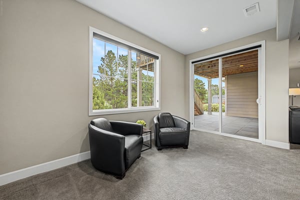 Bright and inviting living space with large windows and direct access to an outdoor patio.