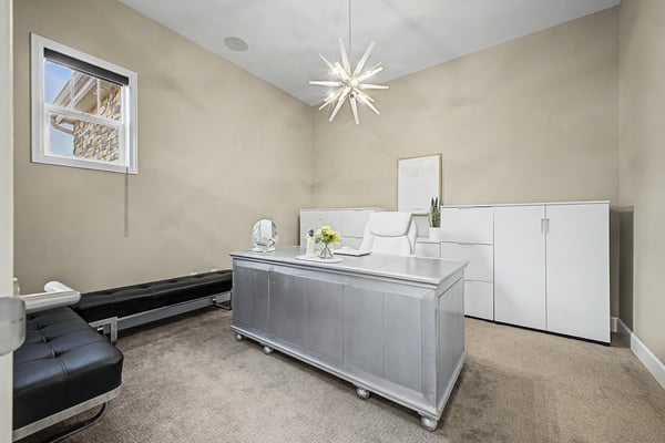 Bright office space featuring contemporary furnishings, ample storage, and a unique pendant light for inspiration.
