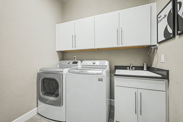 Bright laundry room featuring modern appliances and ample storage, perfect for efficient household management.