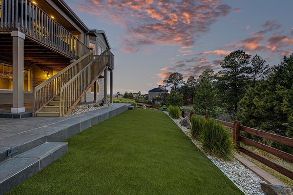 This inviting outdoor space features a spacious lawn and stunning sunset views, perfect for relaxation and gatherings.