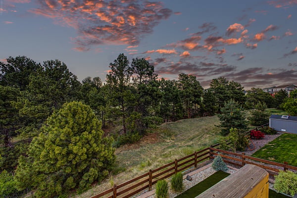 Expansive views of lush greenery and vibrant sunsets create a peaceful retreat in your backyard.