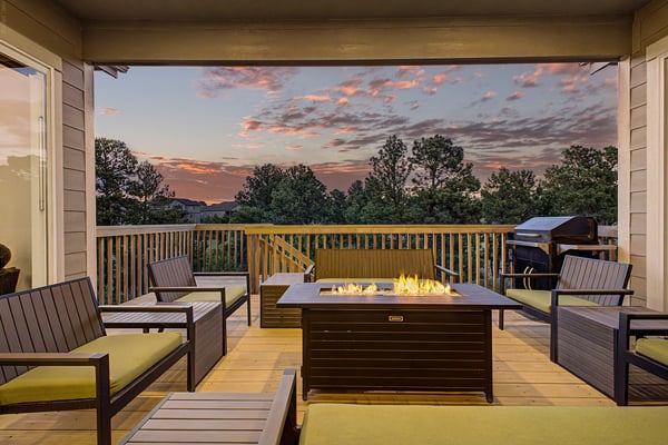 Enjoy stunning sunset views from this cozy deck, featuring a fire pit and ample seating for gatherings.