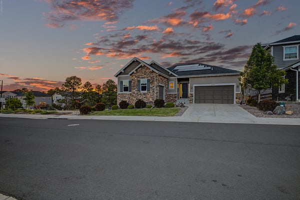 Discover a contemporary home with striking architectural features, set against a picturesque sunset backdrop.
