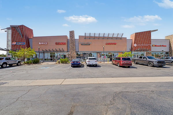Modern retail space featuring diverse businesses, ample parking, and a prime location for high foot traffic.