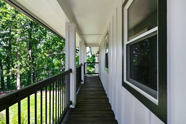 Bright and inviting covered walkway surrounded by lush greenery, offering a unique transition to outdoor living.