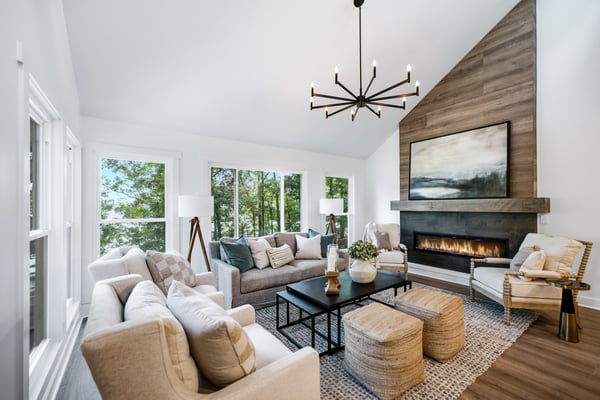 Bright and airy living room featuring large windows, a modern fireplace, and inviting seating arrangements.