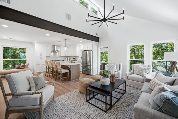 Modern open-concept living area featuring abundant natural light, contemporary fixtures, and a seamless flow to the kitchen.