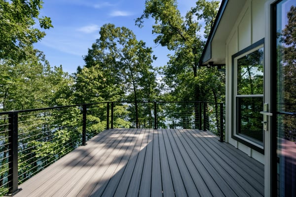Experience lakeside living on this spacious deck, surrounded by lush trees and panoramic water views.