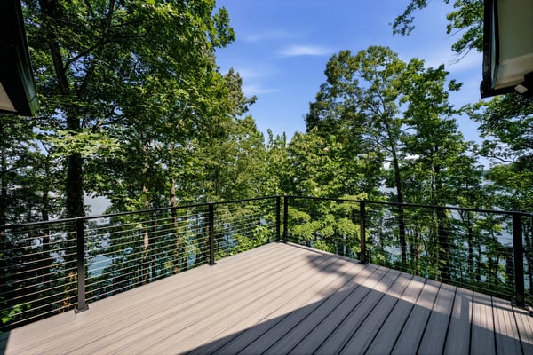 Spacious deck surrounded by vibrant trees, offering stunning lake views and a perfect outdoor retreat.
