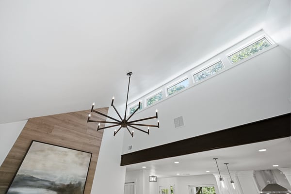 This spacious living area features high ceilings, abundant natural light, and modern architectural details.