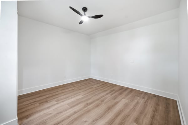 Bright and open space featuring modern flooring and a sleek ceiling fan, perfect for personalized design.