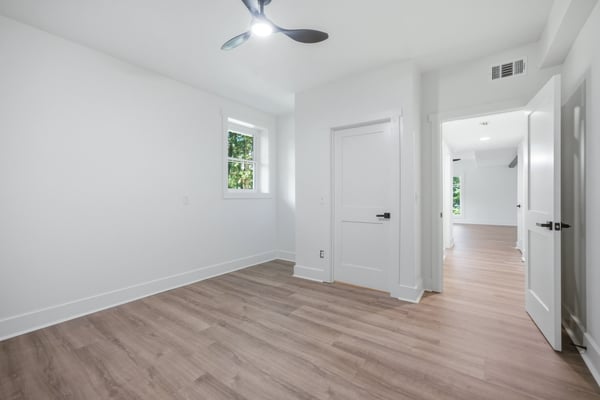 Bright, spacious bedroom featuring modern finishes and ample natural light, perfect for relaxed living.
