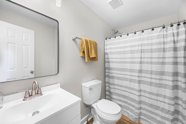 Modern bathroom featuring a clean design, updated fixtures, and ample natural light for a refreshing experience.