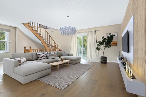 Bright and spacious living area features a unique design, natural light, and direct access to the outdoor space.