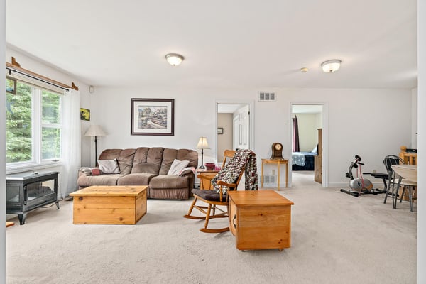 Spacious living area featuring natural light, modern furnishings, and versatile layout for comfort and functionality.