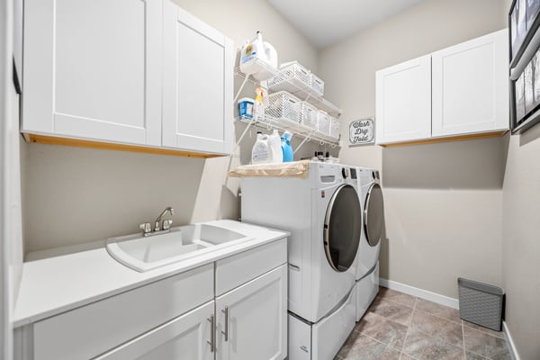 Laundry room off of the entry and walks through to primary suite.