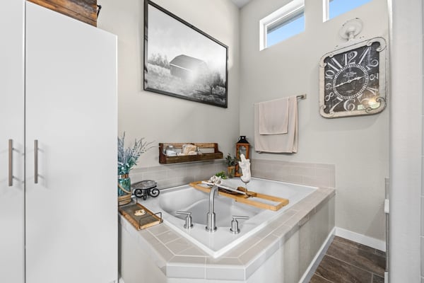 Primary Suite with attached 5 piece bath and walk in closet.