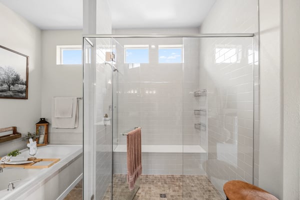 Primary Suite with attached 5 piece bath and walk in closet.