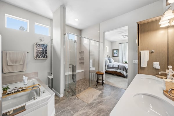 Primary Suite with attached 5 piece bath and walk in closet.