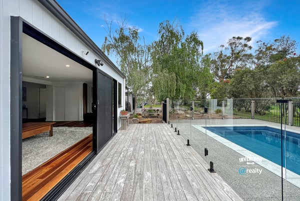 Modern home featuring open spaces, seamless indoor-outdoor flow, and a refreshing pool set amidst nature.